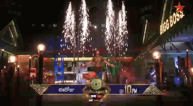 a man is dancing in front of a big boss sign