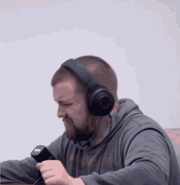 a man wearing headphones and a grey hoodie that says united states on it