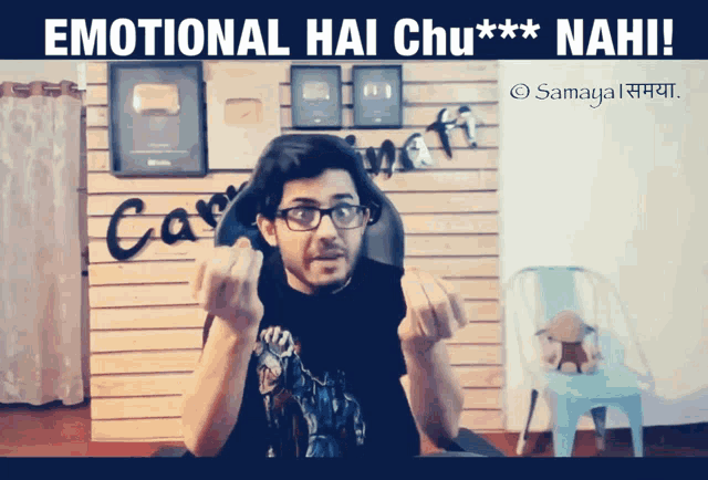 a man giving the middle finger in front of a sign that says emotional hai chu * * * nahi