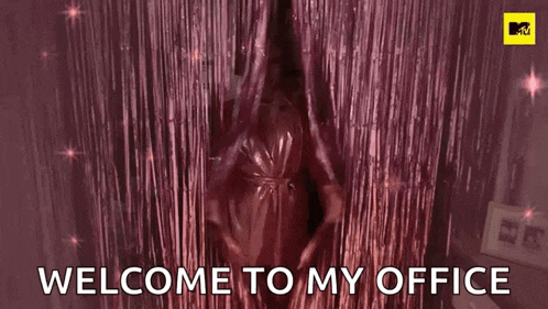 a woman in a pink robe is standing in front of a pink curtain with the words `` welcome to my office '' .