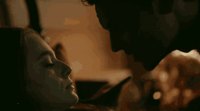 a man and a woman are kissing in the dark