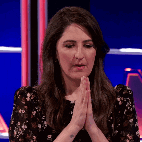 a woman with a tattoo on her arm is praying