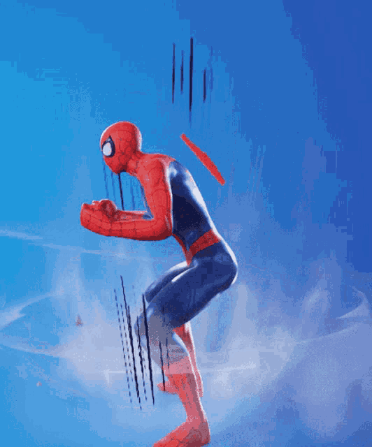 a man in a spiderman costume is squatting down in front of a blue sky