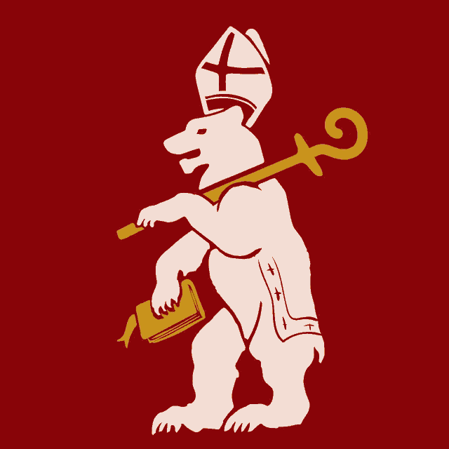 a bear wearing a bishop 's hat and holding a book and a cane