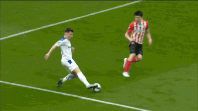 a soccer player with the number 7 on his jersey is dribbling the ball