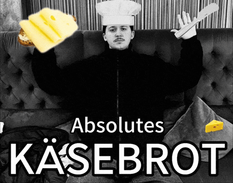 a man in a chef 's hat is holding a knife and cheese