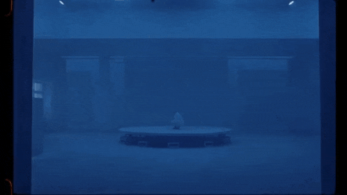 a blue room with a round table in the middle of it