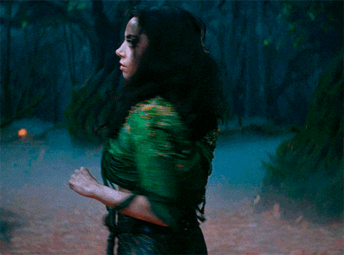 a blurry picture of a woman in a green dress