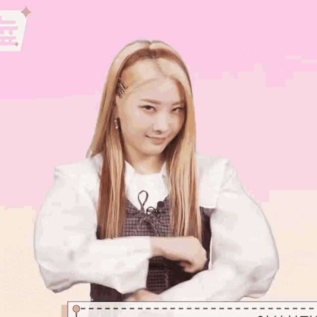 a girl with long blonde hair and a white shirt is making a funny face .