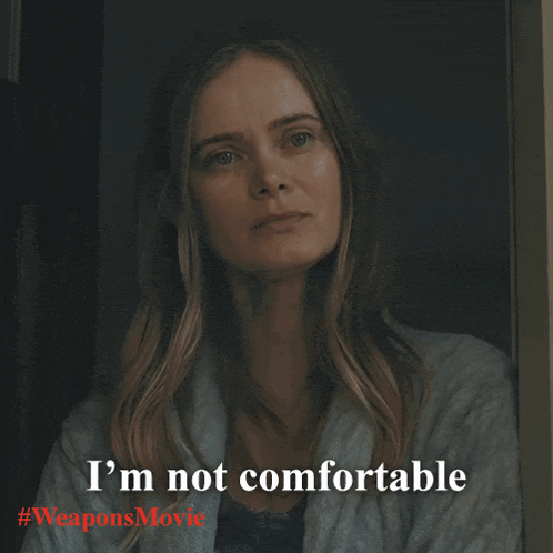 a woman says i 'm not comfortable in front of a weapons movie poster