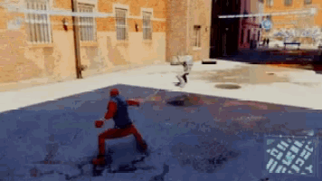 a man in a red spiderman suit is standing on a blue court