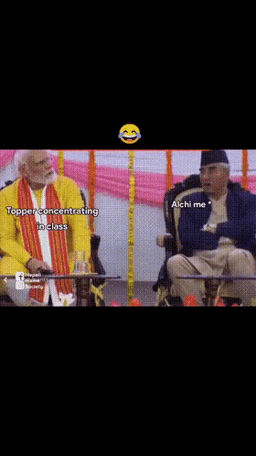 two men are sitting next to each other and one of them is wearing a yellow shirt