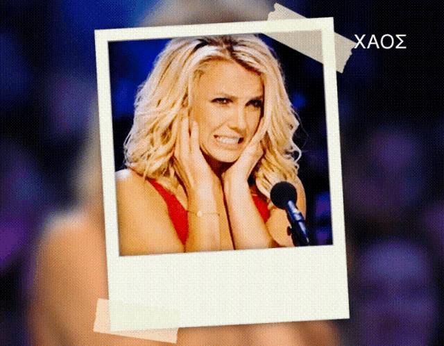 a picture of britney spears is taped to a wall with the word xaos written on it