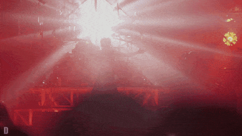a blurred image of a stage with the letter d on the bottom right