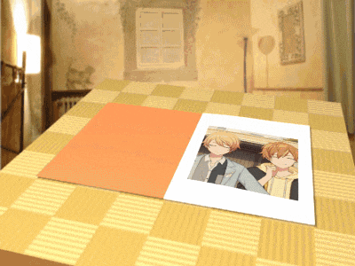 a picture of two anime characters is sitting on a table