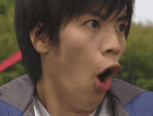 a close up of a person 's face with a surprised look on his face