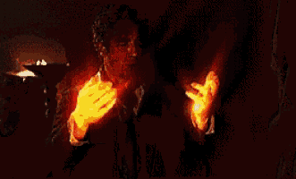 a man in a suit and tie is holding a candle in his hand