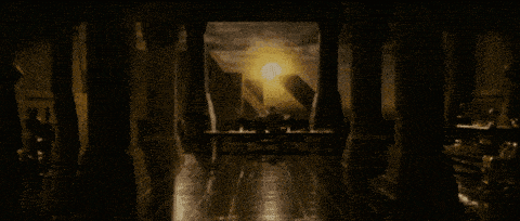 the sun is shining through the pillars of a dark room