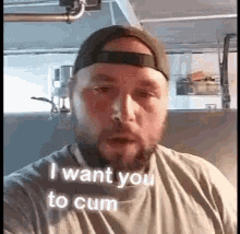 a man with a beard and a hat is taking a selfie and saying `` i want you to cum `` .