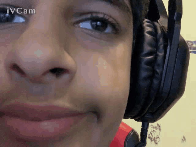 a close up of a person wearing headphones with the words ivcam in the background