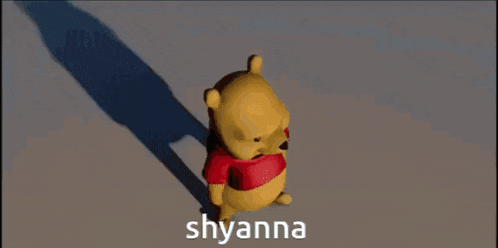 a winnie the pooh bear wearing a red shirt with the name shyanna written on it