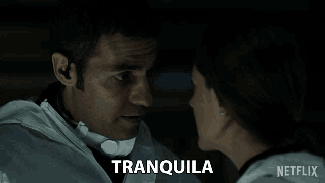 a man and a woman are looking at each other and the word tranquila is on the screen