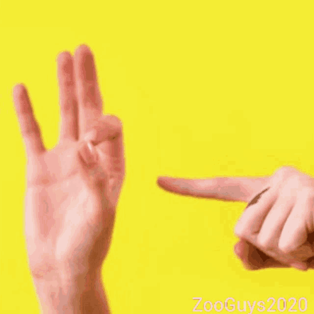 a person is making a peace sign with their fingers .