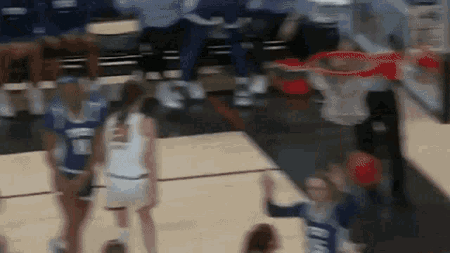 a blurred image of a basketball game with the number 10 on the back of a player 's jersey