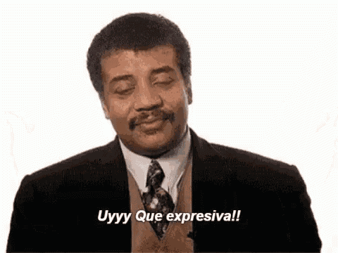 a man in a suit and tie is making a funny face and saying uyyy que expresiva !