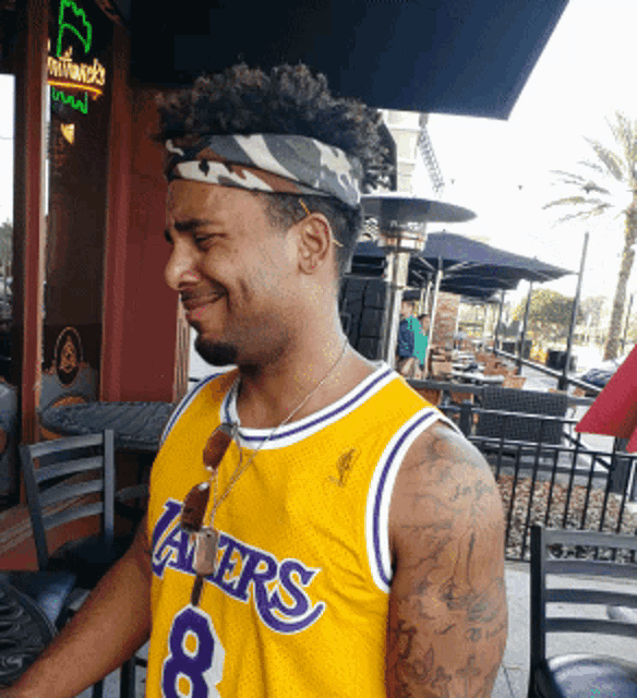 a man wearing a lakers jersey with the number 8
