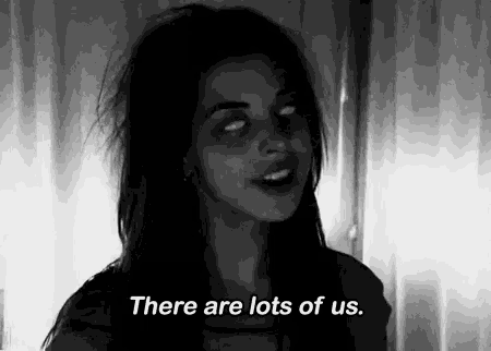 a black and white photo of a woman with white eyes and the words there are lots of us .