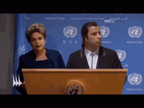 a man and a woman stand at a podium in front of a sign that says nations unidas