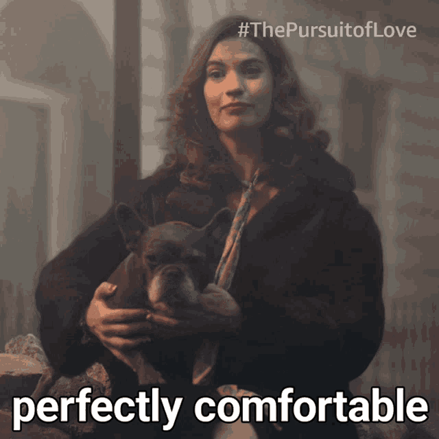 a picture of a woman holding a dog that says perfectly comfortable