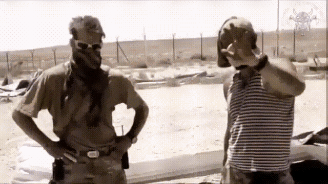two men standing next to each other with one wearing a striped shirt