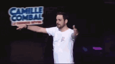 a man in a white shirt stands in front of a sign that says camille collins
