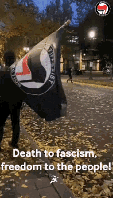 a person holding a flag that says death to fascism