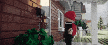 a lego man in a red hat stands on a porch