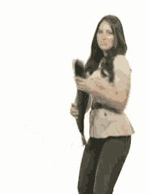 a woman is holding a large fish in her arms
