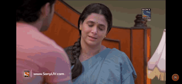 a man and woman are looking at each other on a sony tv show