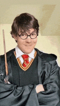 a man dressed as harry potter holding a wand