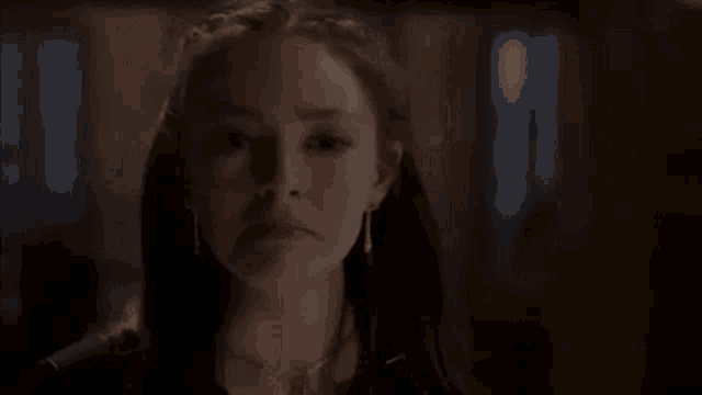 a close up of a woman 's face with a sad look on her face .