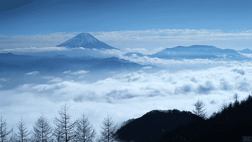 a mountain covered in snow is surrounded by clouds and the word orbo is on the bottom