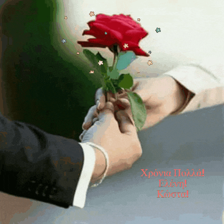 a man in a suit is holding a red rose