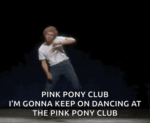 a man in a white shirt is dancing on a stage .
