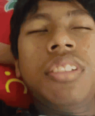a close up of a man 's face with his eyes closed and a smiley face