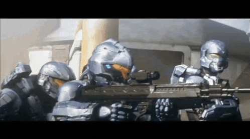 a group of soldiers are holding guns in front of a building and one of them is wearing a blue helmet