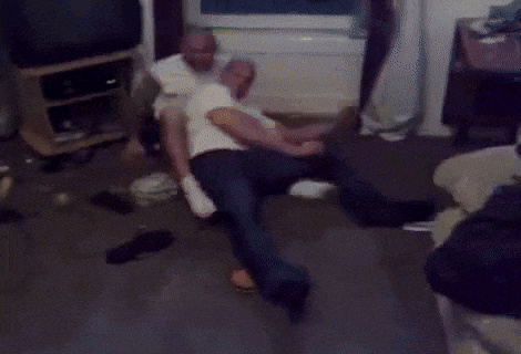 a blurry picture of two men sitting on a couch .