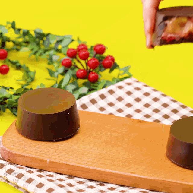 a person is holding a piece of chocolate in their hand