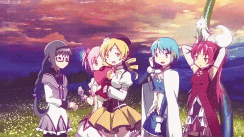a group of anime girls standing next to each other with one holding a cat