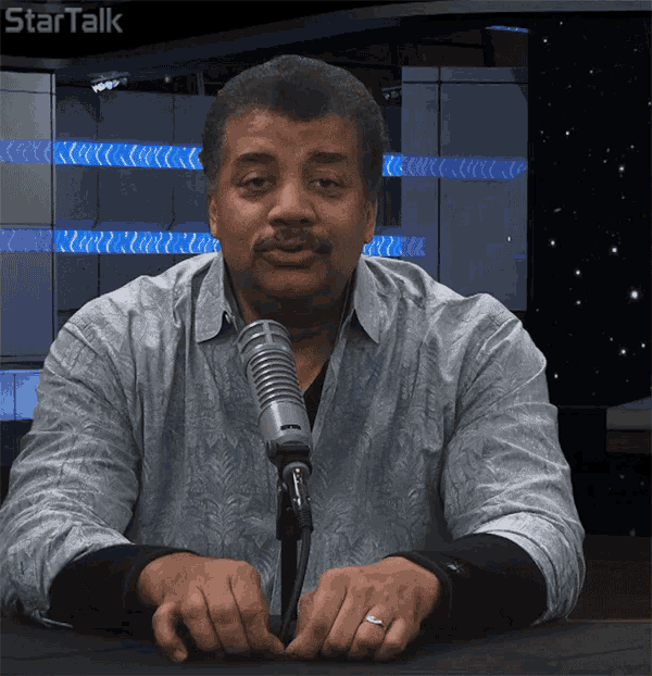 a man sitting in front of a microphone with startalk written on the bottom